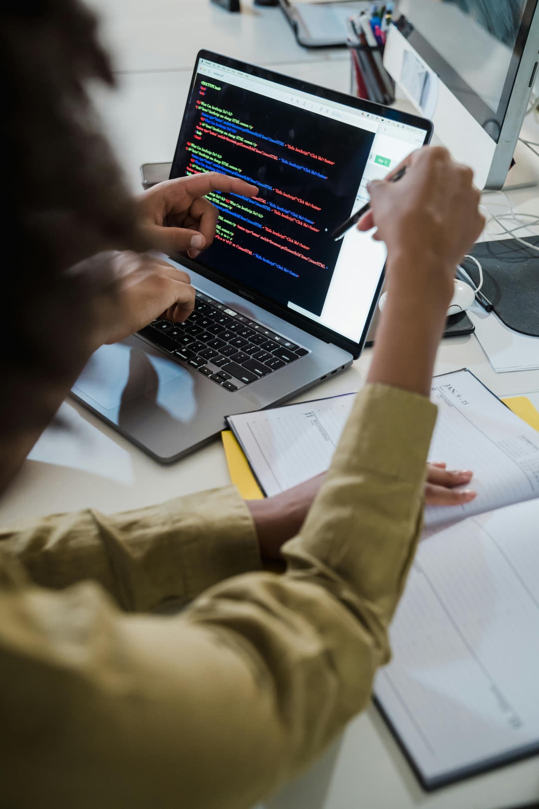 Developer reviewing code on a laptop